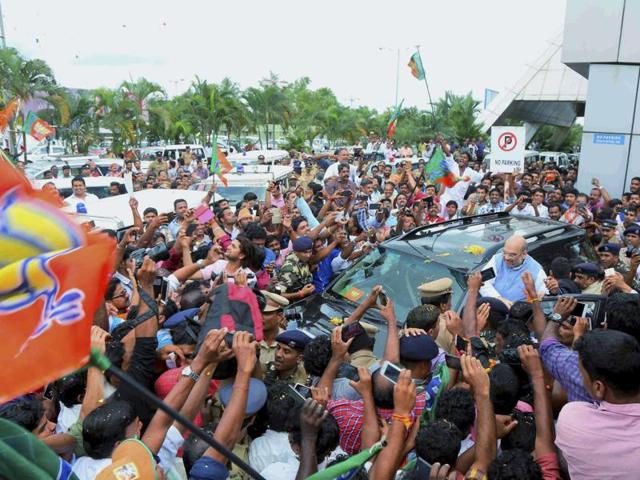 BJP president Amit Shah is welcomed by party workers on his arrival at the aiport in Kozhikode on Thursday.(PTI)