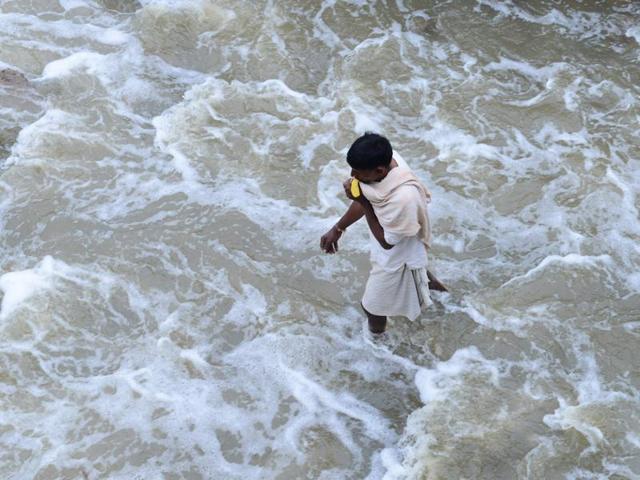 A man walks along a flooded street following heavy rain in Nijampet, a low lying area on the outskirts of Hyderabad on Wednesday. (AFP) A man walks along a flooded street following heavy rain in Nijampet, a low lying area on the outskirts of Hyderabad on Wednesday. (AFP)