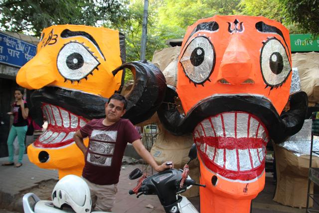 A man poses with Ravan effigies almost ready to be delivered to different parts of the city. (Shivam Saxena/HT Photo) A man poses with Ravan effigies almost ready to be delivered to different parts of the city. (Shivam Saxena/HT Photo)