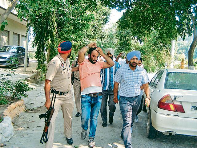 Police taking the accused into custody at Sultanpur Lodhi in Kapurthala district on Thursday. (HT Photo) Police taking the accused into custody at Sultanpur Lodhi in Kapurthala district on Thursday. (HT Photo)