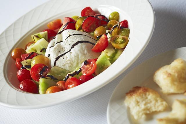 In the burrata salad, everything but the cheese is good; its dome has been flamed until the skin feels like leather.