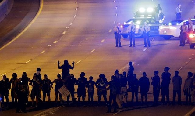 Protesters block a street during a third night of unrest following Tuesday's police shooting of Keith Lamont Scott. (AP) Protesters block a street during a third night of unrest following Tuesday's police shooting of Keith Lamont Scott. (AP)