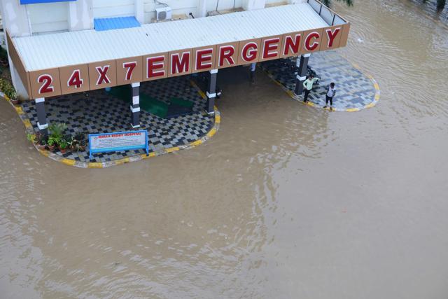 People wait outside the emergency block of a private hospital surrounded by floodwatwers, following heavy rain in Suraram, a low lying area on the outskirts of Hyderabad. (AFP) People wait outside the emergency block of a private hospital surrounded by floodwatwers, following heavy rain in Suraram, a low lying area on the outskirts of Hyderabad. (AFP)
