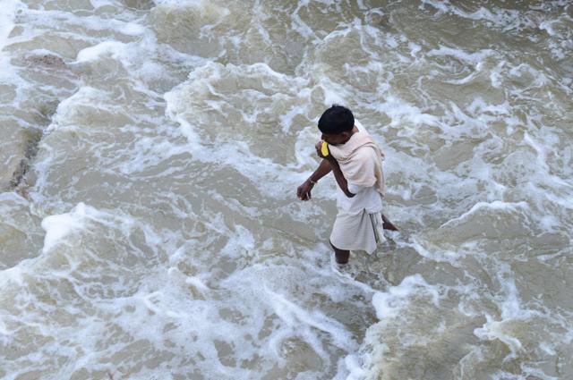 Man walks along a flooded street following heavy rain in Nijampet, a low lying area on the outskirts of Hyderabad. (AFP) Man walks along a flooded street following heavy rain in Nijampet, a low lying area on the outskirts of Hyderabad. (AFP)