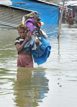 Mman carries his belongings along a flooded street, following heavy rain in Nijampet, a low lying area on the outskirts of Hyderabad on September 21, 2016. (AFP) Mman carries his belongings along a flooded street, following heavy rain in Nijampet, a low lying area on the outskirts of Hyderabad on September 21, 2016. (AFP)