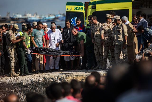 Egyptian coast guard and rescue workers bring ashore a body from a Europe-bound boat that capsized off Egypt’s Mediterranean coast, in Rosetta, Egypt. (AP) Egyptian coast guard and rescue workers bring ashore a body from a Europe-bound boat that capsized off Egypt’s Mediterranean coast, in Rosetta, Egypt. (AP)
