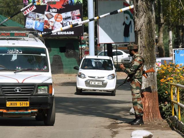 A soldier stands guard at the checkpost near Uri Army Brigade on Thursday. The road, passing through the brigade headquarters connecting 12 villages close to the LoC, was opened to civilian traffic after remaining closed for four days in view of the recent attack on the army base (PTI) A soldier stands guard at the checkpost near Uri Army Brigade on Thursday. The road, passing through the brigade headquarters connecting 12 villages close to the LoC, was opened to civilian traffic after remaining closed for four days in view of the recent attack on the army base (PTI)