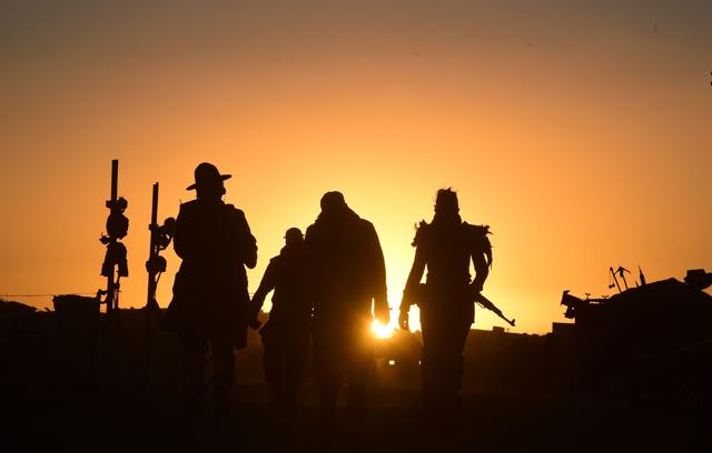 Festival goers arriving at sunset attend the first day of Wasteland Weekend. (AFP)