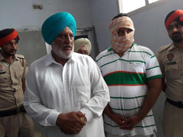 Akali leader Paramjeet Singh and his son Gurjeet Singh in police custody in Baghapurana, Moga, on Saturday.(HT Photo) Akali leader Paramjeet Singh and his son Gurjeet Singh in police custody in Baghapurana, Moga, on Saturday.(HT Photo)