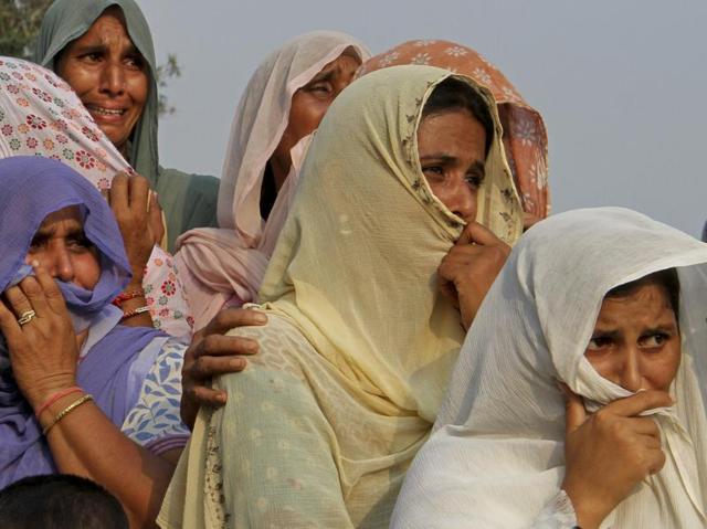Women watch the funeral of soldier Ravi Paul who was killed in Sunday's militant attack in Uri, at Sarwa village, Samba district, Jammu and Kashmir, on September 19, 2016. (Channi Anand/AP) Women watch the funeral of soldier Ravi Paul who was killed in Sunday's militant attack in Uri, at Sarwa village, Samba district, Jammu and Kashmir, on September 19, 2016. (Channi Anand/AP)