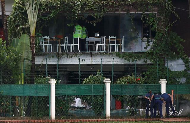 Policemen sneak a look inside the Holey Artisan Bakery and the O'Kitchen Restaurant as others inspect the site after gunmen attacked, in Dhaka. (Reuters File Photo) Policemen sneak a look inside the Holey Artisan Bakery and the O'Kitchen Restaurant as others inspect the site after gunmen attacked, in Dhaka. (Reuters File Photo)