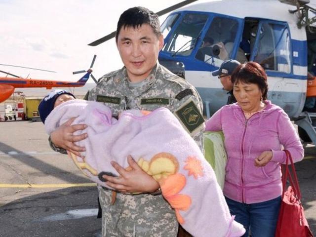 A special force soldier carries Tserin Dopchut after his rescue. (AP) A special force soldier carries Tserin Dopchut after his rescue. (AP)