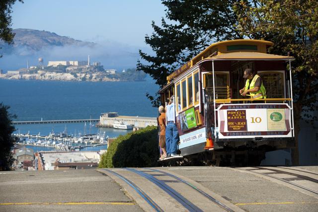 A cable car, an iconic mode of San Francisco transportation meets an iconic landmark, Alcatraz Prison, at the top of Hyde Street. (pius99) A cable car, an iconic mode of San Francisco transportation meets an iconic landmark, Alcatraz Prison, at the top of Hyde Street. (pius99)