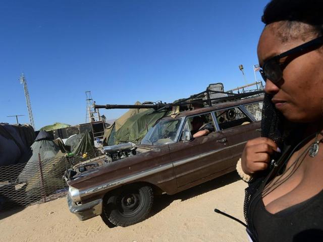 In combat boots, satin thongs and matching nipple tassels, the burlesque girls of the apocalypse celebrate the end of the world deep in the merciless dust of the Mojave Desert. (AFP) 