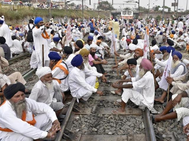 Farmers sitting on railway track in Amritsar on Sunday. (Gurpreet Singh/HT Photo) Farmers sitting on railway track in Amritsar on Sunday. (Gurpreet Singh/HT Photo)