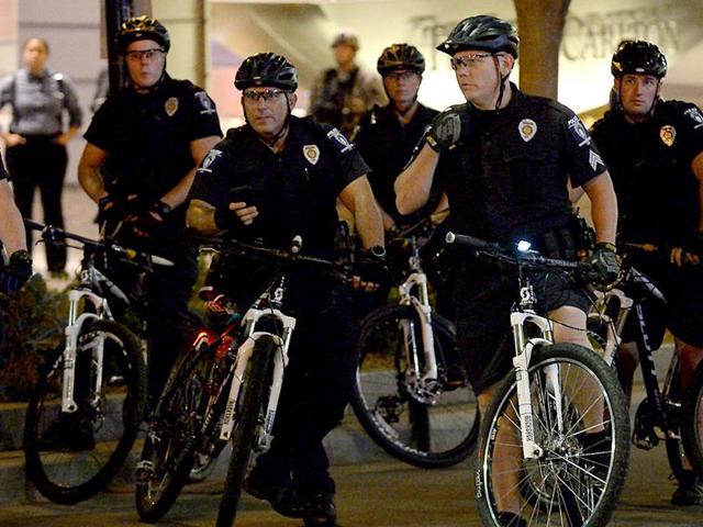 Charlotte-Mecklenburg bicycle police officers watch as protesters congregate near the intersection of Trade and College Streets in Charlotte.(AP) Charlotte-Mecklenburg bicycle police officers watch as protesters congregate near the intersection of Trade and College Streets in Charlotte.(AP)