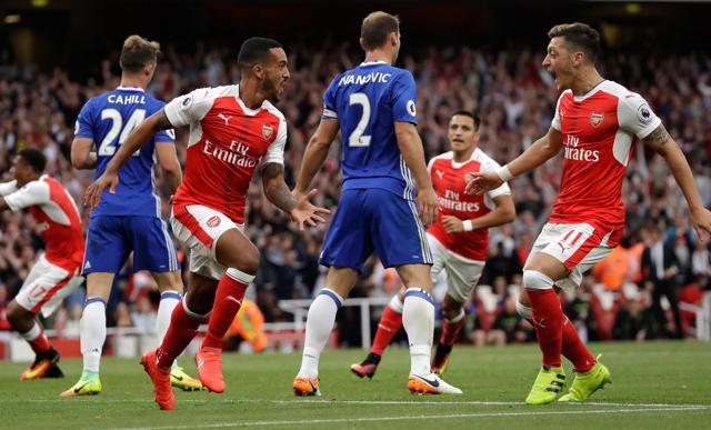 Arsenal's Theo Walcott, center left, celebrates with Mesut Ozil, right, and Alexis Sanchez after scoring his side's second goal during the English Premier League soccer match between Arsenal and Chelsea at the Emirates Stadium in London. (AP) Arsenal's Theo Walcott, center left, celebrates with Mesut Ozil, right, and Alexis Sanchez after scoring his side's second goal during the English Premier League soccer match between Arsenal and Chelsea at the Emirates Stadium in London. (AP)