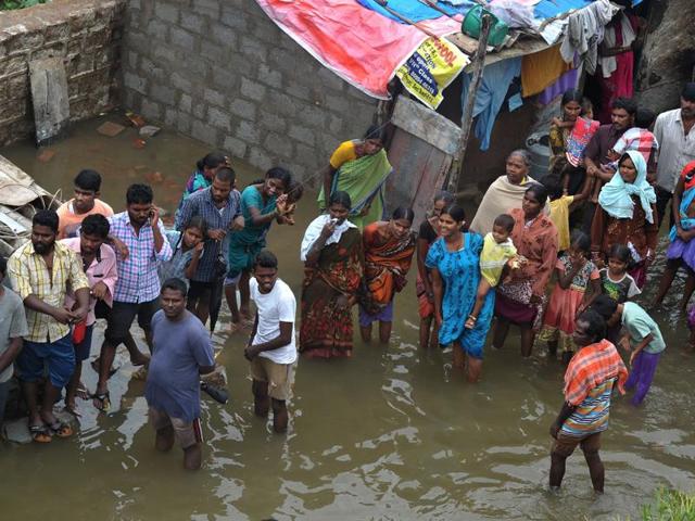 Residents stand in floodwater outside their homes following heavy rain in Alwal, on the outskirts of Hyderabad. (AFP File Photo) Residents stand in floodwater outside their homes following heavy rain in Alwal, on the outskirts of Hyderabad. (AFP File Photo)