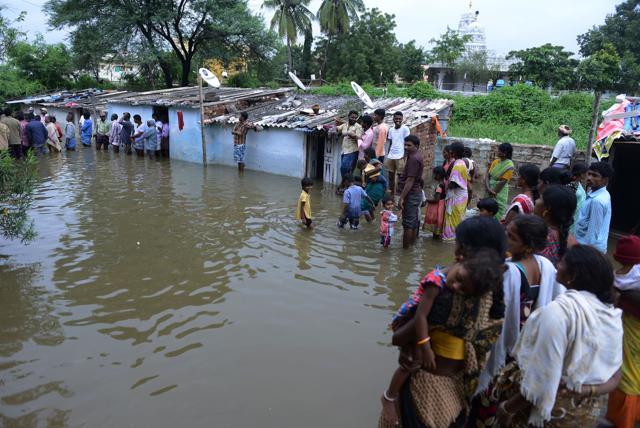 Residents stand in floodwater outside their homes following heavy rain in Alwal on the outskirts of Hyderabad on September 23, 2016. (AFP) Residents stand in floodwater outside their homes following heavy rain in Alwal on the outskirts of Hyderabad on September 23, 2016. (AFP)
