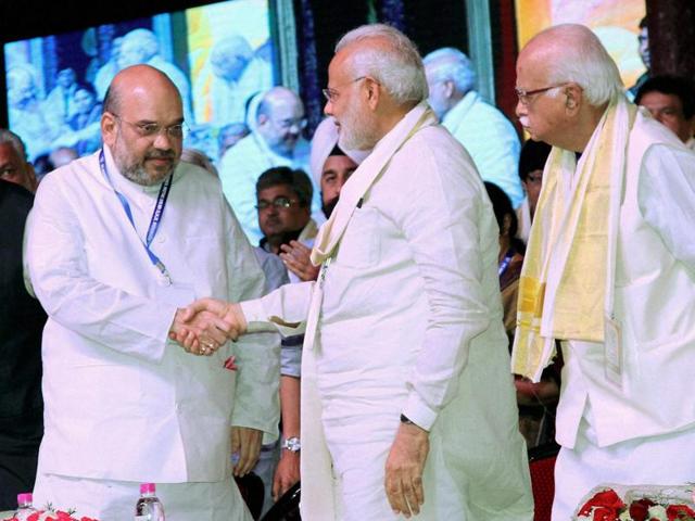 Prime Minister Narendra Modi shakes hands with BJP president Amit Shah during BJP's National Council Meeting at Kozhikode on Sunday.(PTI) Prime Minister Narendra Modi shakes hands with BJP president Amit Shah during BJP's National Council Meeting at Kozhikode on Sunday.(PTI)