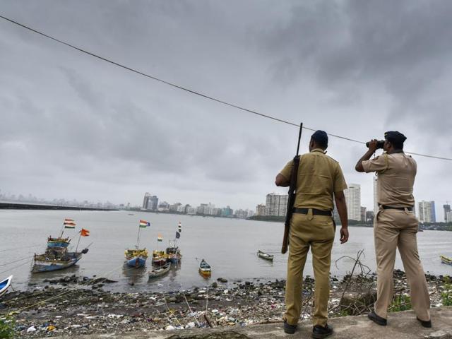 Police personnel stand guard at the coast on Friday.(HT Photo)