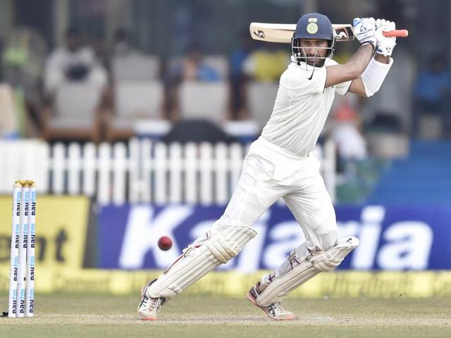 New Zealand's Tom Latham (L) makes an unsuccessfull attempt to stop a shot by India's Cheteshwar Pujara.(AFP Photo) New Zealand's Tom Latham (L) makes an unsuccessfull attempt to stop a shot by India's Cheteshwar Pujara.(AFP Photo)