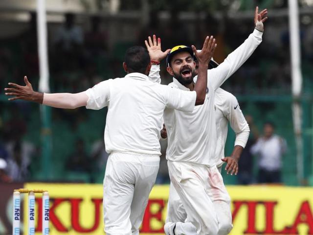 India’s captain Virat Kohli celebrates the wicket of New Zealand's BJ Watling with bowler Mohamed Shami (left) on the fifth day of their first cricket Test match at Green Park Stadium in Kanpur.(AP Photo)