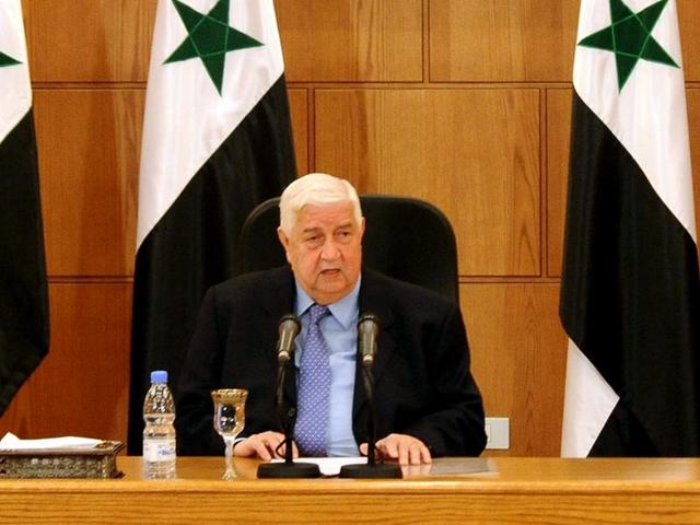 This March 12, 2016 file photo released by the Syrian official news agency SANA shows Syrian foreign minister Walid al-Moallem sitting beneath a portrait of Syrian President Bashar Assad as he speaks during a press conference in Damascus. (AP file photo) This March 12, 2016 file photo released by the Syrian official news agency SANA shows Syrian foreign minister Walid al-Moallem sitting beneath a portrait of Syrian President Bashar Assad as he speaks during a press conference in Damascus. (AP file photo)
