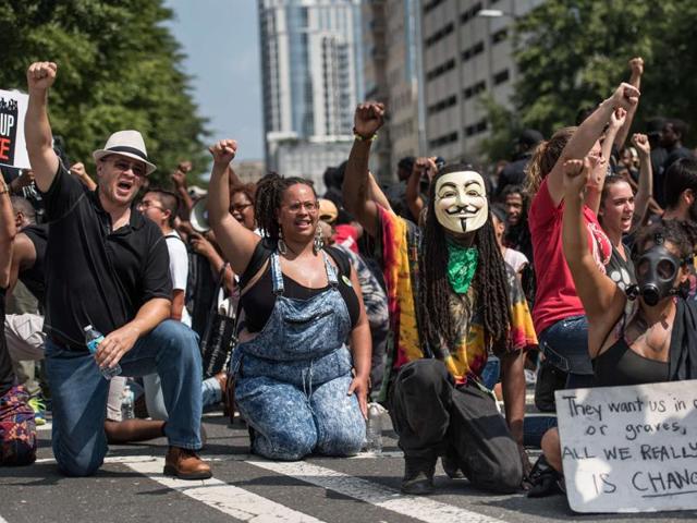 Demonstrators take a knee during the national anthem outside Bank of America Stadium before an NFL football game between the Charlotte Panthers and the Minnesota Vikings in Charlotte, North Carolina on Sunday.(AFP) Demonstrators take a knee during the national anthem outside Bank of America Stadium before an NFL football game between the Charlotte Panthers and the Minnesota Vikings in Charlotte, North Carolina on Sunday.(AFP)