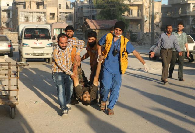 Syrian rescue workers and residents carry the body of a victim following a reported air strike in the rebel-held Salaheddin district of Aleppo. (AFP Photo) Syrian rescue workers and residents carry the body of a victim following a reported air strike in the rebel-held Salaheddin district of Aleppo. (AFP Photo)