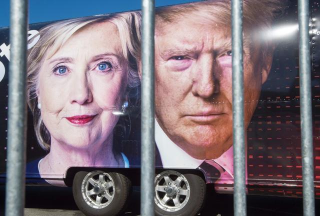 Large images of Democratic nominee Hillary Clinton and Republican nominee Donald Trump are seen on a CNN vehicle, behind a security fence at Hofstra University, in Hempstead, New York. (AFP Photo) Large images of Democratic nominee Hillary Clinton and Republican nominee Donald Trump are seen on a CNN vehicle, behind a security fence at Hofstra University, in Hempstead, New York. (AFP Photo)