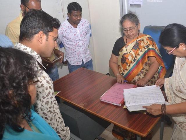 Indore mayor Malini Gaud inspects records at a zonal office on the first day of her ward scan on Monday.(Shankar Mourya/HT Photo)