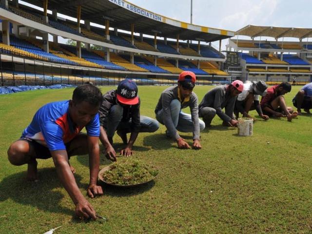 Groundsmen prepare field at Indore’s Holkar Stadium on Monday.(Shankar Mourya/HT Photo)