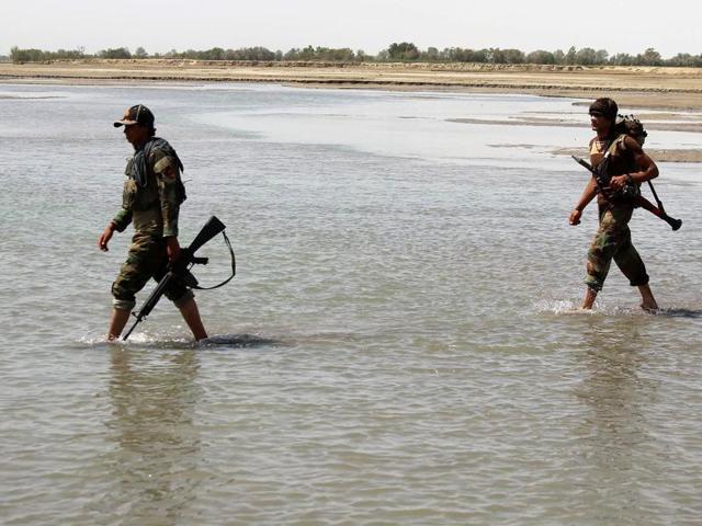 Afghan security forces patrol near the Alchin Afghan-Tajik transit bridge damaged by militants during fighting in Kunduz.(AFP file photo)