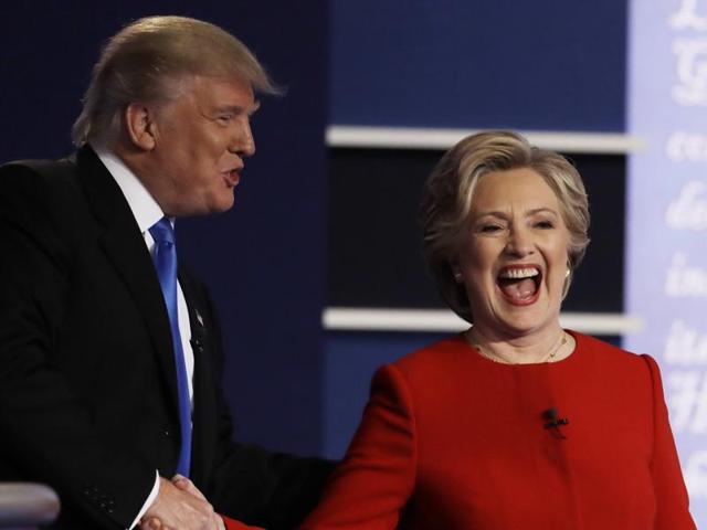 Republican presidential nominee Donald Trump listens to Democratic presidential nominee Hillary Clinton during the presidential debate at Hofstra University in Hempstead, N.Y.(AP)