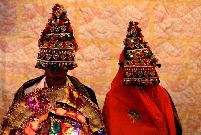 A bride and groom wearing traditional handmade garlands wait for their wedding to start during a mass marriage ceremony in the southern Pakistani city of Karachi.(Reuters file photo) A bride and groom wearing traditional handmade garlands wait for their wedding to start during a mass marriage ceremony in the southern Pakistani city of Karachi.(Reuters file photo)