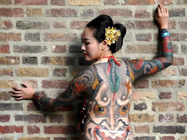 A tattoo enthusiast poses for the camera. The continental vibes are so stunning here. (REUTERS) A tattoo enthusiast poses for the camera. The continental vibes are so stunning here. (REUTERS)