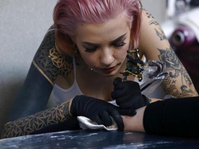 A woman is tattooed at the convention. More than 400 international tattoo artists will be practising their skills in public during the three-day event. (REUTERS) A woman is tattooed at the convention. More than 400 international tattoo artists will be practising their skills in public during the three-day event. (REUTERS)
