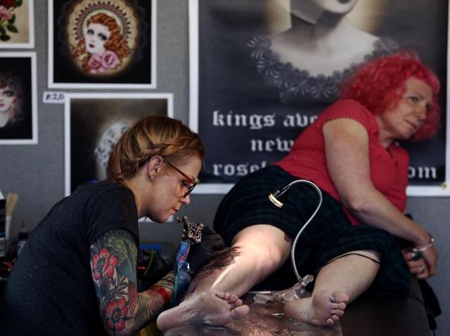 Another woman getting inked. The event also featured entertainers and rock bands taking to the stage. (REUTERS) Another woman getting inked. The event also featured entertainers and rock bands taking to the stage. (REUTERS)