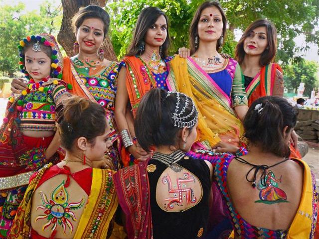 Colourful clothes and oxidised silver jewellery is so predictable. Girls are going the extra mile this year to show their enthusiasm. Notice the many tattoos. (PTI) Colourful clothes and oxidised silver jewellery is so predictable. Girls are going the extra mile this year to show their enthusiasm. Notice the many tattoos. (PTI)