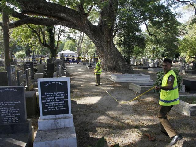 Sri Lankan crime investigating police officers prepare to exhume the remains of murdered newspaper editor Lasantha Wickrematunge at a cemetery in Colombo on Tuesday following a court order for a fresh investigation. Wickrematunge, editor of the Sunday Leader newspaper, was killed while driving to work in January 2009.(AP) Sri Lankan crime investigating police officers prepare to exhume the remains of murdered newspaper editor Lasantha Wickrematunge at a cemetery in Colombo on Tuesday following a court order for a fresh investigation. Wickrematunge, editor of the Sunday Leader newspaper, was killed while driving to work in January 2009.(AP)