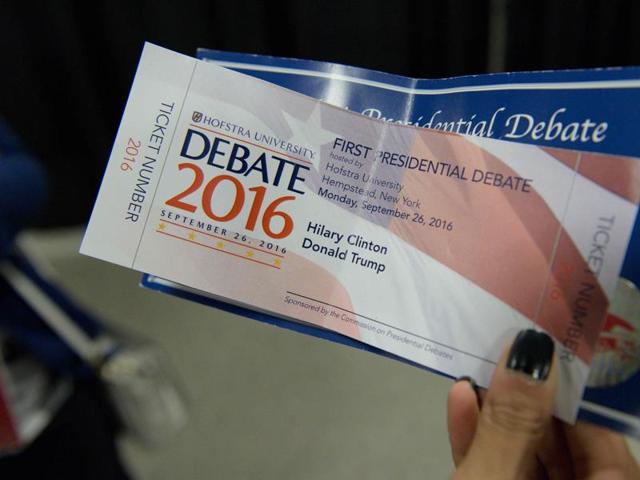 A woman holds a Presidential debate ticket with the name "Hilary" misspelled during the first presidential debate at Hofstra University in Hempstead. (AFP Photo)