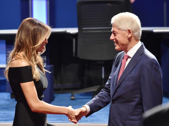 Melania Trump and former US president Bill Clinton check hands before the first presidential debate at Hofstra University in Hempstead, New York. (AFP Photo)