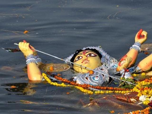 Durga idol immersion processions offer the most colourful pageantry on Kolkata streets.(HT Photo)