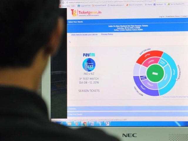 A cricket fan trying to book a ticket for the match online.(HT)