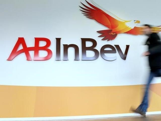 A man walks past the logo of Anheuser-Busch InBev at the brewer's headquarters in Leuven, Belgium.(Reuters File)