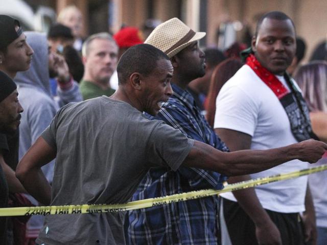 A man points at police as he and others yell while at the scene where a black man was shot by police in El Cajon, east of San Diego, California. (AP Photo) A man points at police as he and others yell while at the scene where a black man was shot by police in El Cajon, east of San Diego, California. (AP Photo)