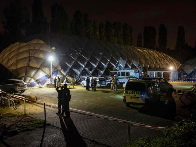 Policemen stand in front of an airdome housing a refugee shelter in Berlin, where a 29-year-old refugee was shot dead by the police.(AFP Photo)
