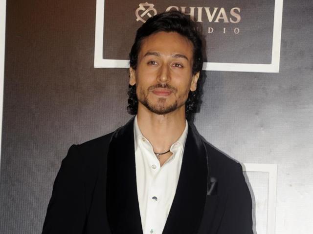 Tiger Shroff kept it cool and simple with a black jacket over a white shirt. (AFP)