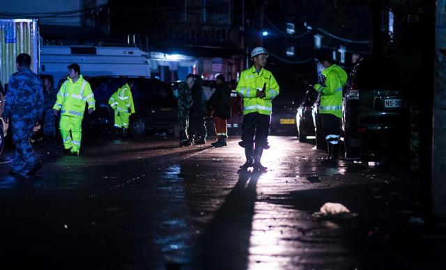 Policemen walk on a street after a landslide hit the village of Sucun in Suichang county, east China's Zhejiang province on September 29. (AFP) Policemen walk on a street after a landslide hit the village of Sucun in Suichang county, east China's Zhejiang province on September 29. (AFP)